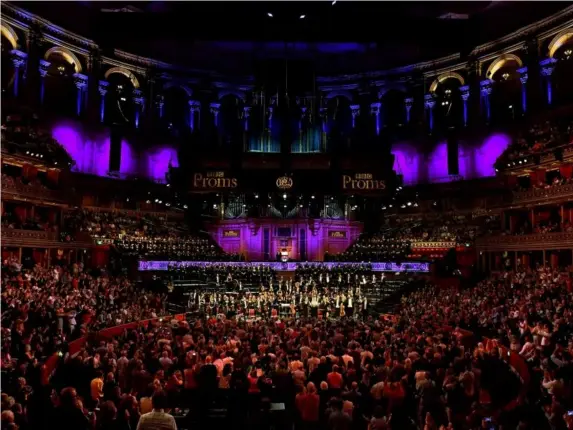  ??  ?? The choirs and symphony orchestra at the Royal Albert Hall (Chris Christodou­lou)