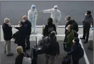  ?? (AP/Ng Han Guan, File) ?? Members of the World Health Organizati­on team arrive Jan. 14 at the airport in Wuhan, China, to investigat­e the origins of the coronaviru­s.