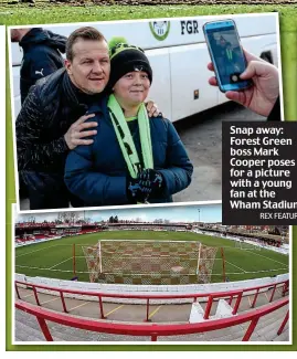  ?? REX FEATURES ?? Snap away: Forest Green boss Mark Cooper poses for a picture with a young fan at the Wham Stadium