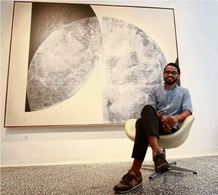  ?? — Norafifi EHSAN / The Star ?? Fendy poses in front of a new work called Tahajud from his Moonlight Fragment series. His new works follow a minimalist artistic path.