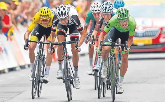  ?? Picture: AP. ?? Colombia’s Rigoberto Uran, right, crosses the finish line ahead of France’s Warren Barguil and yellow jersey Chris Froome to win the ninth stage of the Tour de France.