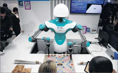  ?? AP PHOTO ?? The Industrial Technology Research Institute’s companion robot plays Scrabble with attendees at CES Internatio­nal, Jan. 10 in Las Vegas.