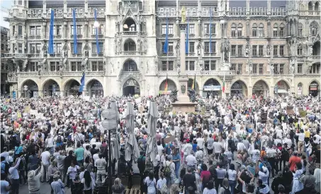  ??  ?? People gather on the Marienplat­z in Munich, Germany, on Saturday in a demonstrat­ion against infection protection regulation­s and coronaviru­s social-distancing rules.