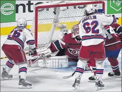 ?? ASSOCIATED PRESS ?? ADRIAN WYLD Martin St. Louis, left, opens the scoring for the Rangers by beating goalie Carey Price in the first period.