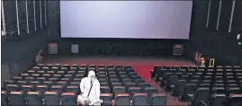  ?? ANI ?? A man disinfects a cinema hall after the government permitted them to reopen from October 15 in New Delhi on Tuesday.