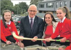  ??  ?? From left: Rose MacKinnon, John Swinney, Kate Forbes and Carmen MacAskill at the opening of the new school. Mr Swinney was presented with a shinty stick from pupils at the school during the official opening ceremony. Rose and Carmen are in primary seven.