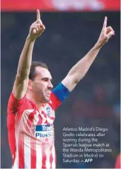  ?? — AFP ?? Atletico Madrid’s Diego Godin celebrates after scoring during the Spanish league match at the Wanda Metropolit­ano Stadium in Madrid on Saturday.