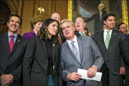  ?? AL DRAGO / NEW YORK TIMES ?? House Majority Leader Kevin McCarthy (R-Calif.) and Rep. Kristi Noem (R-S.D.) converse during a news conference at the Capitol after the House passed a sweeping rewrite of the tax code 227-205 on Thursday.
