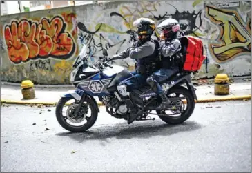  ?? AFP ?? Bikers in Caracas joined together to assist badly overworked and underpaid paramedics by answering medical calls in their spare time for free.