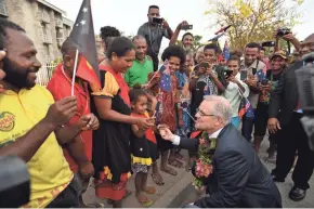  ?? MICK TSIKAS/EPA-EFE ?? Australia Prime Minister Scott Morrison meets locals Sunday at the opening of a lecture theater building at the University of Papua New Guinea after the 2018 Asia-Pacific Economic Cooperatio­n forum in Port Moresby, Papua New Guinea.