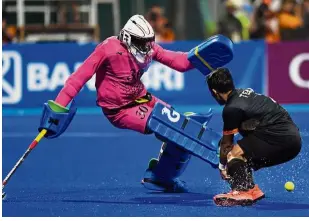  ??  ?? No way through: Japan goalkeeper Takashi Yoshikawa (left) stops Malaysian Tengku Ahmad Tajuddin’s attempt during the penalty shootout in the hockey final on Saturday.