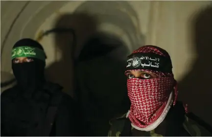  ??  ?? HAMAS MEMBERS stand inside an attack tunnel in Gaza in August 2014.