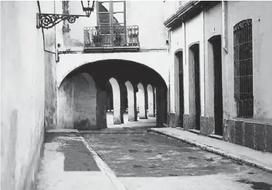  ?? ?? Calle de Marín hacia 1940. Al fondo, el arco de entrada a la Plaza Vieja y a la izquierda, la pared en la que empezaban las dependenci­as del convento de Las Claras, derribada para la construcci­ón de la cruz de los caídos.