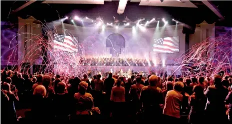  ?? STAFF PHOTOS BY ROBIN RUDD ?? Streamers shoot over the crowd Sunday at the close of a patriotic musical number during an event at Abba’s House in Hixson.