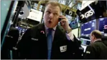  ?? RICHARD DREW — THE ASSOCIATED PRESS ?? Trader George Ettinger works Jan. 25 on the floor of the New York Stock Exchange.