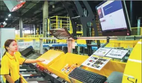  ?? PHOTOS PROVIDED TO CHINA DAILY ?? An employee operates an automatic sorting system in a warehouse of Suning Holdings Group Ltd in Nanjing, Jiangsu province.