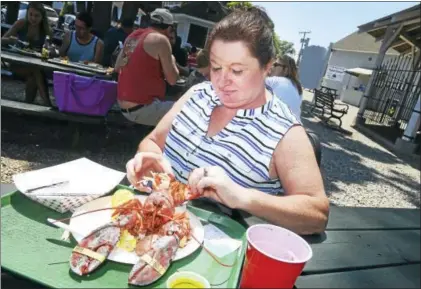 ?? FILE PHOTO ?? Karen Letourneau of Bristol eats lobster for lunch at Lenny & Joe’s Fish Tale in Madison.