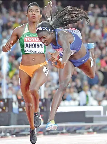  ??  ?? — AFP Tori Bowie of the USA dives to cross the finish line ahead of Ivory Coast’s Murielle Ahoure to win the women’s 100 metres final at the World Athletics Championsh­ips in London on Sunday.