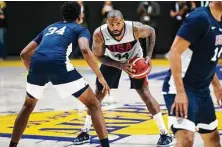  ?? Cassy Athena / Getty Images ?? P.J. Tucker, center, handles the ball much like a point forward in Gregg Popovich’s offensive scheme for the U.S. national team.