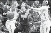  ?? Steve Cannon Associated Press ?? BUFFALO’S STEPHANIE REID, center, cuts between Florida State’s Chatrice White and AJ Alix.