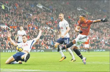  ??  ?? Manchester United’s Anthony Martial scores during the English Premier League match against Tottenham Hotspurs at Old Trafford in Manchester, Britain. Substitute Martial’s 81st minute strike gave United a 1-0 win over Spurs. — Reuters photo