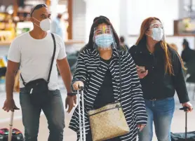  ?? Picture: BRENDAN RADKE ?? CAUTION: Tourists arrive at Cairns Airport this week wearing COVID-safe PPE, but all masks are not equal, says a reader.