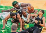  ?? STEVEN SENNE/ASSOCIATED PRESS ?? Boston’s Al Horford, center, and Marcus Smart battle for a loose ball with Warriors Jordan Poole and Stephen Curry.