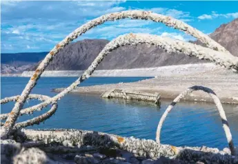  ?? L.E. BASKOW/LAS VEGAS REVIEW-JOURNAL VIA AP ?? A WWII-era landing craft used to transport troops or tanks along with old steel cable nearby was revealed Thursday on the shoreline near the Lake Mead Marina as the waterline continues to lower at the Lake Mead National Recreation Area in Boulder City, Nevada.