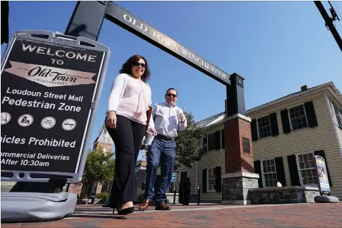  ?? Associated Press ?? ■ Pedestrian­s walk along the downtown mall area Wednesday in Winchester, Va. The viral pandemic has hammered small businesses across the United States, an alarming trend for an economy that’s trying to rebound from the deepest, fastest recession in U.S. history. Small companies are struggling in Winchester, a city of 28,000 that works hard to promote and preserve local enterprise­s.