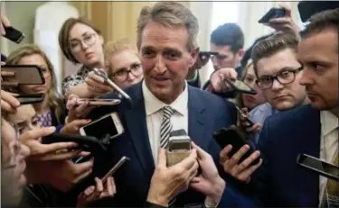  ?? ANDREW HARNIK — THE ASSOCIATED PRESS ?? In this photo, Sen. Jeff Flake, R-Ariz., center, speaks with reporters after meeting with Senate Majority Leader Mitch McConnell of Ky. in his office in the Capitol in Washington. Flake is stoking new speculatio­n about a possible presidenti­al run as he emerges as a central figure in the explosive debate over President Donald Trump’s Supreme Court pick. Flake was scheduled to speak in New Hampshire Monday evening, his second appearance this year in the state that hosts the nation’s first presidenti­al primary election.