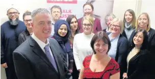  ??  ?? Lancashire Police and Crime Commission­er Clive Grunshaw, left, with Claire Powell, regional manager at Victim Support, right, and staff