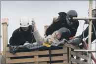  ?? PICTURES: SIMON HULME. ?? TROUBLE BREWING: Police move tea lady Jackie Brooks from her table at the Kirby Misperton fracking site to enable them to remove a pallet tower and arrest protester Eddie, above.