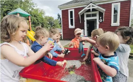  ??  ?? Children play outside Strawbery Vale Preschool. The facility serves 34 children in a historic 1893 building.