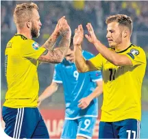  ??  ?? Johnny Russell celebrates in San Marino with Ryan Fraser