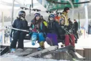  ??  ?? Happy skiers and snowboarde­rs ride the Black Mountain Express lift Friday as Arapahoe Basin opened for the season. Andy Cross, The Denver Post