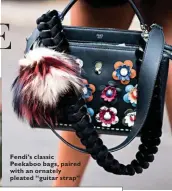  ??  ?? Fendi’s classic Peekaboo bags, paired with an ornately pleated “guitar strap”