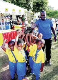  ?? ROOKWOOD LIONEL ?? AT LEFT: Norbrook Cup champions Emmanuel A celebrate with the winning trophy after the presentati­on ceremony at Emmanuel Christian Academy last March. At right is coach Gregory Jones. Emmanuel is expected to feature at today’s Victory Cup competitio­n.