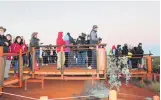  ??  ?? Here comes the sun . . . Hundreds of tourists waiting on the sunrise platform to take that early morning photo of Uluru.