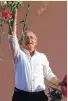  ?? Lefteris Pitarakis / AP ?? Opposition leader Kemal Kilicdarog­lu throws flowers to supporters at a rally.