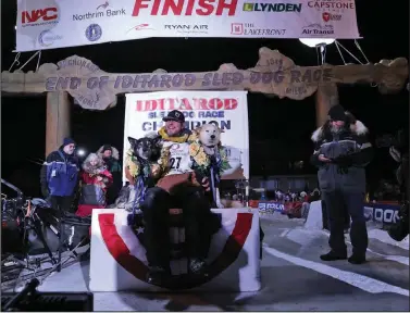  ?? ?? WILD AND FREE— Brent Sass and his dogs Morello and Slater bask in the sweet moment of victory on the champion podium of the 2022 Iditarod.