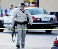  ?? John Locher /the associated press ?? A Las Vegas police officer walks away from the scene of a shooting on June 8 near a Wal-Mart, in Las Vegas. The rise in shooting events is troubling, experts in the U.S. say.