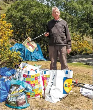  ??  ?? Sean Byrne with some of the rubbish left behind by campers on his land near Lough Dan.