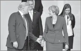  ??  ?? US President Donald Trump gestures as he poses alongside Britain's Prime Minister Theresa May and Iceland's Prime Minister Katrín Jakobsdótt­ir (R) during the opening ceremony of the NATO summit, at the NATO headquarte­rs in Brussels, on Wednesday. AFP