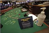  ?? THE ASSOCIATED PRESS ?? Coronaviru­s restrictio­ns at live gaming tables at the Rivers Casino in Pittsburgh. The pandemic took a big bite out of gaming revenue in 2020.