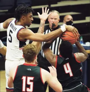  ?? David Butler II / USA Today ?? Hartford’s Moses Flowers (4) has his shot blocked by UConn’s Isaiah Whaley (5) at Gampel Pavilion last month.