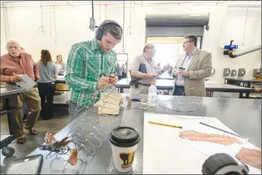  ?? NWA Democrat-Gazette/SPENCER TIREY ?? Mark Latta, a student at Northwest Arkansas Community College, works on 3D design art pieces Friday in one of the studios in the new Integrated Design Lab building. Northwest Arkansas Community College hosted a grand opening for its new building on its Bentonvill­e campus. The building hosts courses in constructi­on, fine arts and computer-aided drafting.