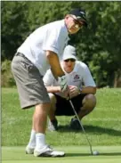  ??  ?? Blind golfer Rick Kush of Guelph, left, with his coach, Gary Cooper. It’s competitio­n and inclusiven­ess they enjoy, Kush says.