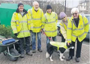  ??  ?? ●● Civic Pride volunteers enlisted the help of border collie Colin and his owner Mike (holding the lead)