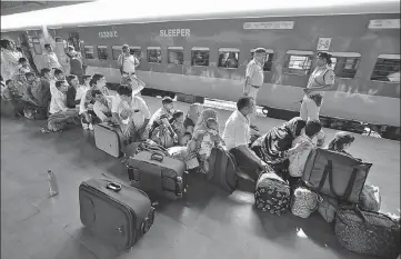  ?? SIDDHARAJ SOLANKI/HTPHOTO ?? ■ Migrants from Uttar Pradesh and Bihar queue up at a railway station in Ahmedabad, Gujarat, on Tuesday.
