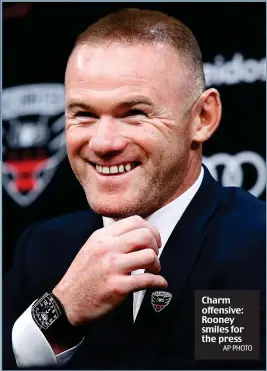  ?? AP PHOTO ?? Charm offensive: Rooney smiles for the press